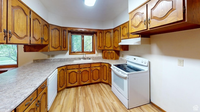 662 N 1600 E, Preston, ID 83263 - kitchen featuring white appliances, under cabinet range hood, a sink, and brown cabinetry