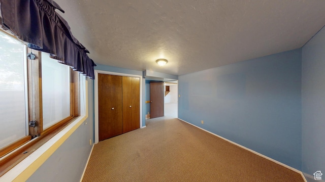 662 N 1600 E, Preston, ID 83263 - unfurnished bedroom featuring light carpet, a closet, baseboards, and a textured ceiling