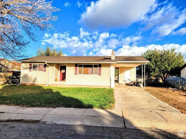 273 S 700 W, Parowan, UT 84761 - single story home featuring a front lawn, driveway, a chimney, and an attached carport