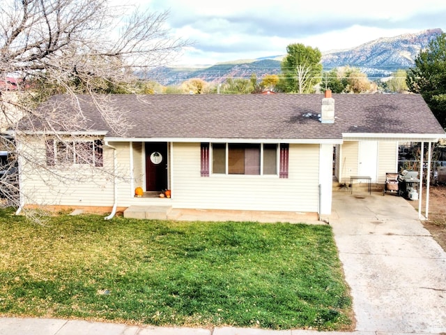 273 S 700 W, Parowan, UT 84761 - ranch-style house featuring concrete driveway, a front lawn, a chimney, and a mountain view