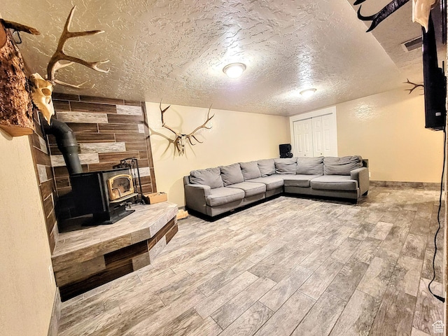 273 S 700 W, Parowan, UT 84761 - living area with a wood stove, a textured ceiling, wood finished floors, and baseboards