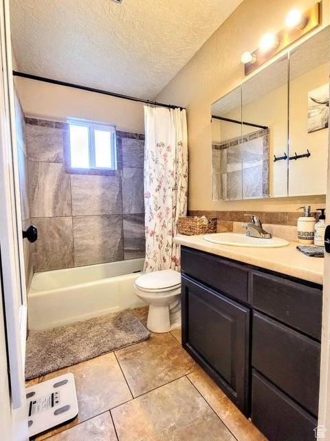 273 S 700 W, Parowan, UT 84761 - full bathroom with shower / tub combo, tile patterned flooring, toilet, a textured ceiling, and vanity