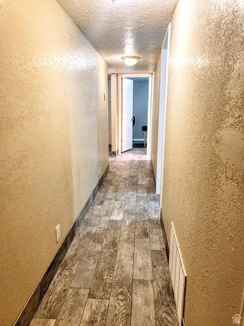 273 S 700 W, Parowan, UT 84761 - hallway featuring dark wood-style flooring and a textured wall