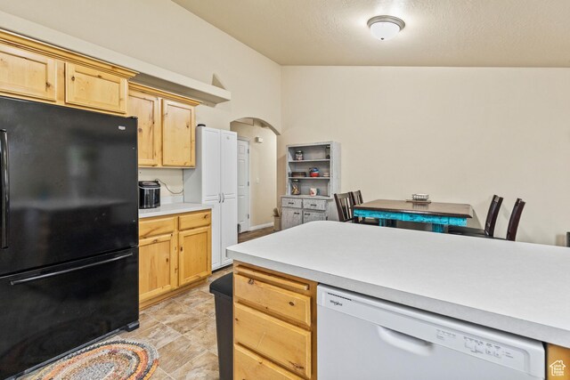 78 N Peach St E, Santaquin, UT 84655 - kitchen with freestanding refrigerator, dishwasher, light brown cabinetry, arched walkways, and light countertops