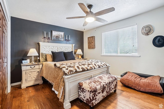 517 E Canyon View Dr N, Ogden, UT 84404 - bedroom featuring wood-type flooring, a textured ceiling, baseboards, and a ceiling fan