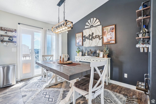 517 E Canyon View Dr N, Ogden, UT 84404 - dining area featuring a chandelier, wood finished floors, baseboards, and a textured ceiling