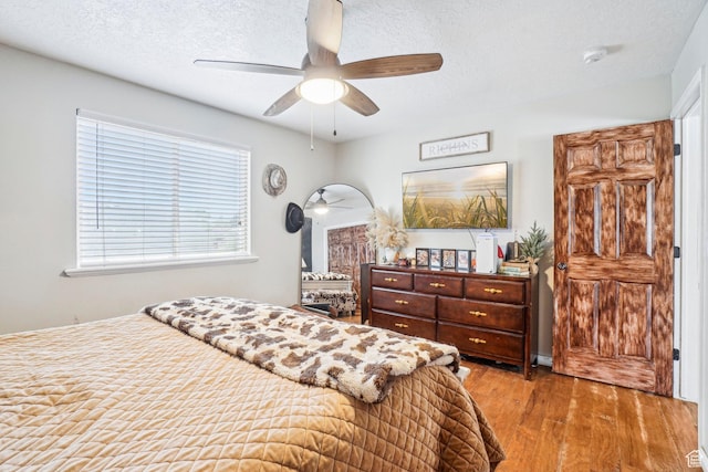 517 E Canyon View Dr N, Ogden, UT 84404 - bedroom with wood finished floors, a textured ceiling, and ceiling fan