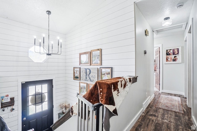 517 E Canyon View Dr N, Ogden, UT 84404 - corridor featuring a chandelier, dark wood-style floors, a textured ceiling, baseboards, and wood walls
