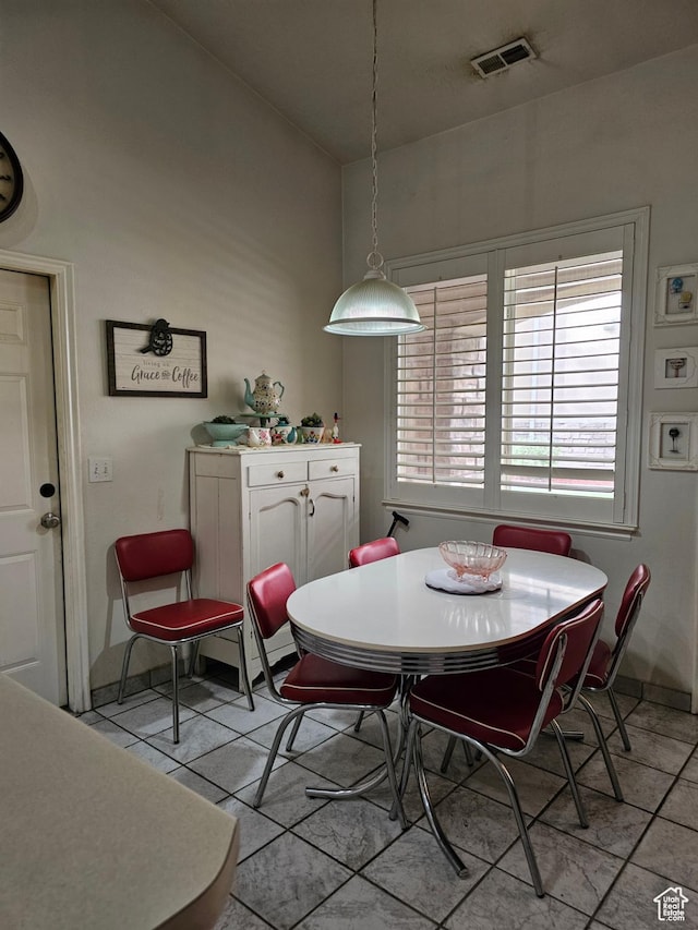 dining area with light tile patterned floors