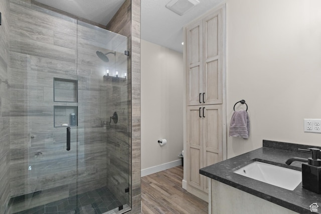 22 Old Ranch Rd, Montpelier, ID 83254 - full bathroom featuring a stall shower, wood finished floors, and vanity