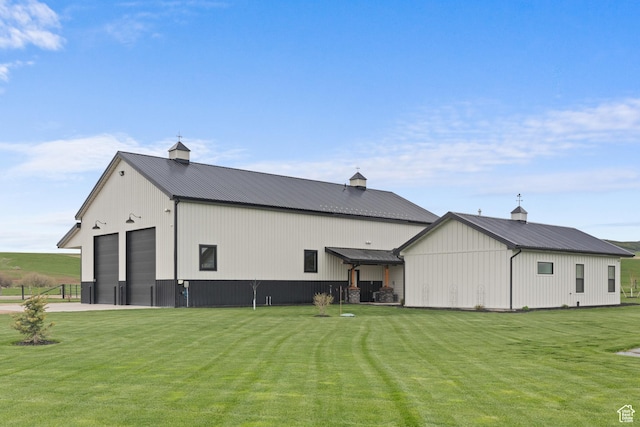 22 Old Ranch Rd, Montpelier, ID 83254 - back of property with a lawn, a pole building, metal roof, and an outdoor structure