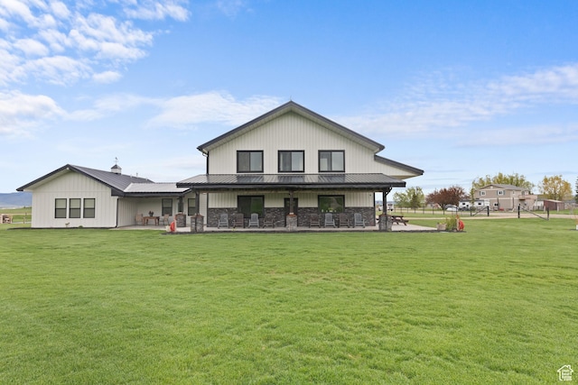 22 Old Ranch Rd, Montpelier, ID 83254 - rear view of property featuring a lawn, a patio area, metal roof, and stone siding