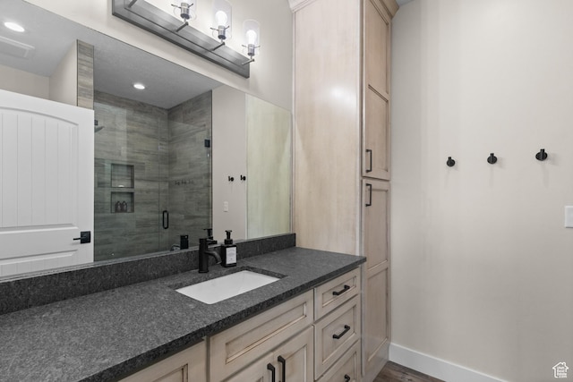 22 Old Ranch Rd, Montpelier, ID 83254 - bathroom featuring a shower stall, vanity, baseboards, recessed lighting, and wood finished floors