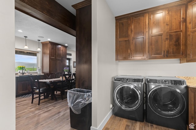 22 Old Ranch Rd, Montpelier, ID 83254 - laundry room with washing machine and dryer, light wood finished floors, cabinet space, baseboards, and recessed lighting