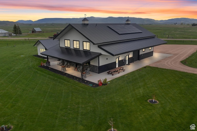 22 Old Ranch Rd, Montpelier, ID 83254 - back of property with a patio area, a mountain view, and solar panels