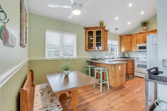861 N 1100 E, Pleasant Grove, UT 84062 - kitchen with white appliances, a wainscoted wall, a peninsula, glass insert cabinets, and light wood-style floors