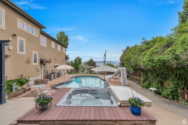 861 N 1100 E, Pleasant Grove, UT 84062 - view of swimming pool featuring a water slide, an in-ground hot tub, and a fenced backyard