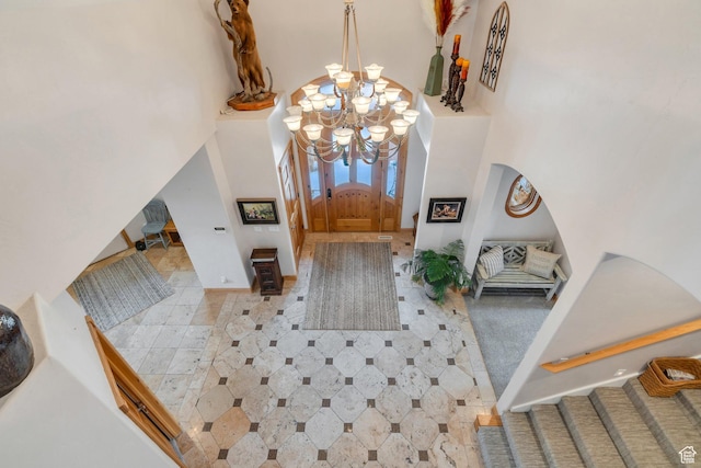 861 N 1100 E, Pleasant Grove, UT 84062 - foyer entrance with a chandelier, a high ceiling, arched walkways, stairs, and baseboards