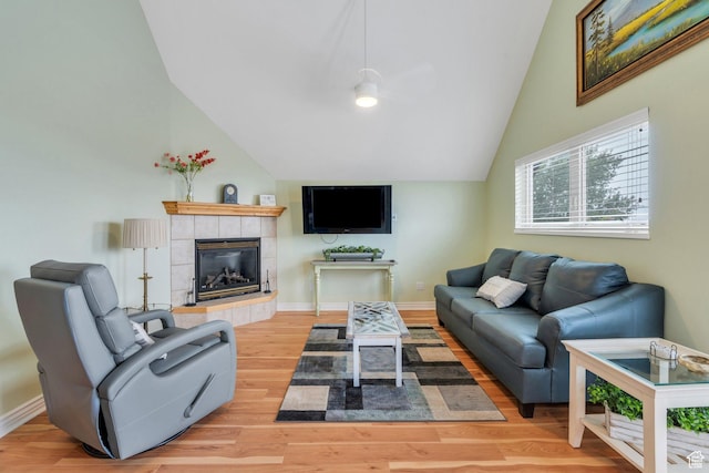 861 N 1100 E, Pleasant Grove, UT 84062 - living room with vaulted ceiling, light wood-style floors, a tiled fireplace, and baseboards