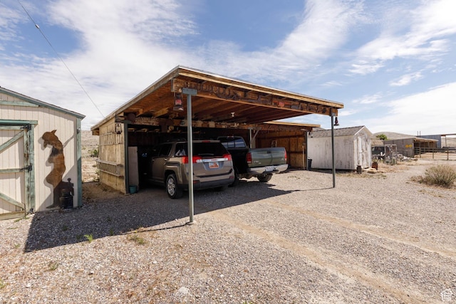 1090 N 200 E, Ferron, UT 84523 - view of parking / parking lot featuring a storage unit, a carport, and driveway