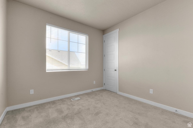 carpeted empty room with baseboards