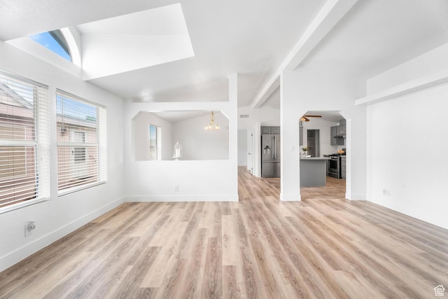39 N 3850 W, Hurricane, UT 84737 - unfurnished living room with a chandelier, light wood finished floors, baseboards, and vaulted ceiling