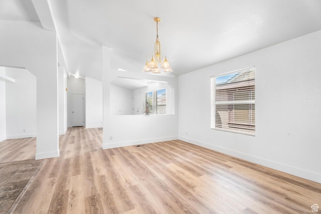 39 N 3850 W, Hurricane, UT 84737 - unfurnished living room with light wood finished floors, a chandelier, baseboards, and lofted ceiling