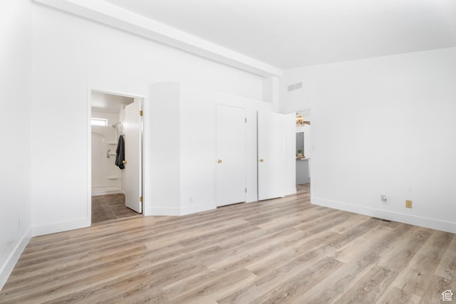 39 N 3850 W, Hurricane, UT 84737 - unfurnished bedroom with lofted ceiling, light wood-type flooring, baseboards, and ensuite bathroom