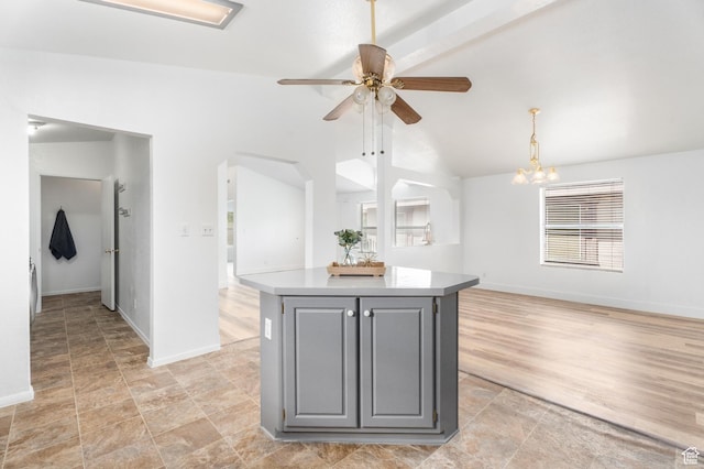 39 N 3850 W, Hurricane, UT 84737 - kitchen with gray cabinets, a ceiling fan, a kitchen island, baseboards, and high vaulted ceiling
