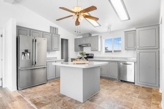 39 N 3850 W, Hurricane, UT 84737 - kitchen with appliances with stainless steel finishes, gray cabinets, under cabinet range hood, vaulted ceiling, and light countertops