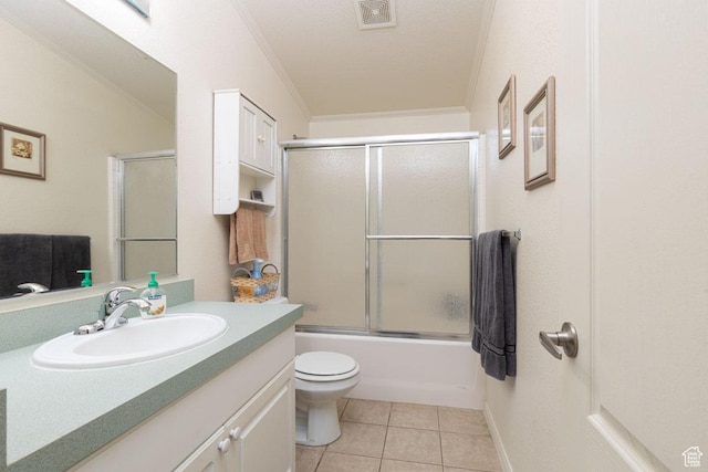 5177 W 1525 S, Cedar City, UT 84720 - bathroom with ornamental molding, vanity, toilet, tile patterned flooring, and bath / shower combo with glass door