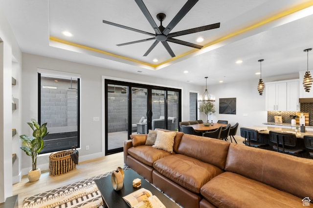 5266 W 2480 S Unit 132, Hurricane, UT 84737 - living room featuring recessed lighting, light wood-style floors, a ceiling fan, baseboards, and a tray ceiling
