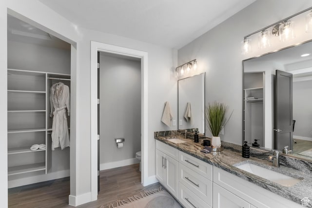 5266 W 2480 S Unit 132, Hurricane, UT 84737 - full bath featuring toilet, wood finished floors, double vanity, a walk in closet, and baseboards