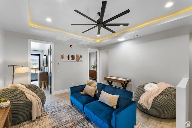 5266 W 2480 S Unit 132, Hurricane, UT 84737 - living area featuring a raised ceiling, ceiling fan, recessed lighting, wood finished floors, and baseboards