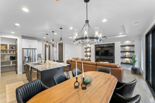 5266 W 2480 S Unit 132, Hurricane, UT 84737 - dining room with light wood-type flooring, recessed lighting, a chandelier, and built in shelves
