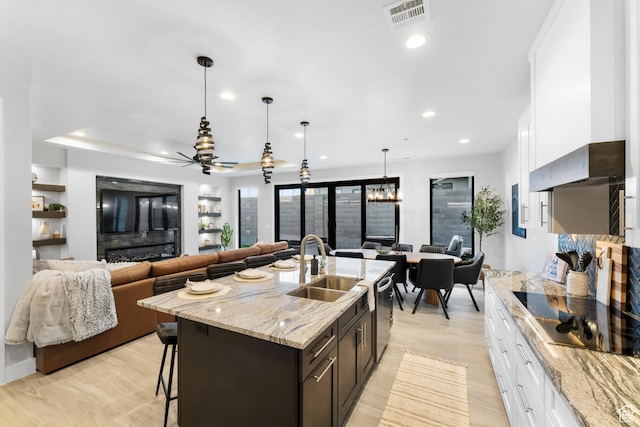 5266 W 2480 S Unit 132, Hurricane, UT 84737 - kitchen with a sink, a kitchen bar, white cabinetry, stainless steel dishwasher, and recessed lighting