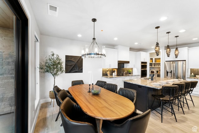 5266 W 2480 S Unit 132, Hurricane, UT 84737 - dining area with recessed lighting, light wood-type flooring, a chandelier, and baseboards