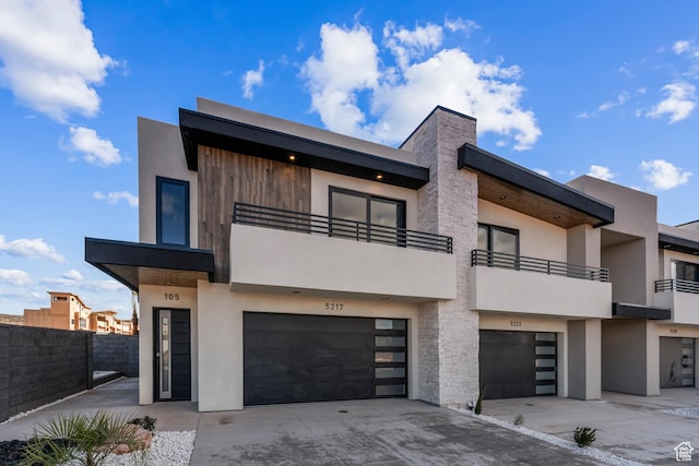 5266 W 2480 S Unit 132, Hurricane, UT 84737 - view of front of property with an attached garage, driveway, stucco siding, fence, and a balcony