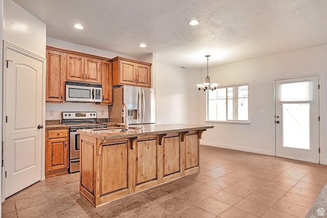 845 S 1840 W, Orem, UT 84059 - kitchen with stainless steel appliances, a chandelier, a kitchen breakfast bar, baseboards, and recessed lighting