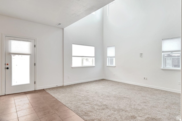 845 S 1840 W, Orem, UT 84059 - empty room featuring light colored carpet, healthy amount of natural light, baseboards, and light tile patterned flooring