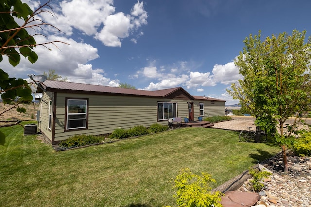 3820 W Main St, Vernal, UT 84078 - back of property featuring central AC unit, a yard, and metal roof