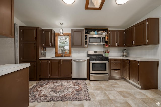 3820 W Main St, Vernal, UT 84078 - kitchen with stainless steel appliances, light countertops, a sink, dark brown cabinets, and vaulted ceiling