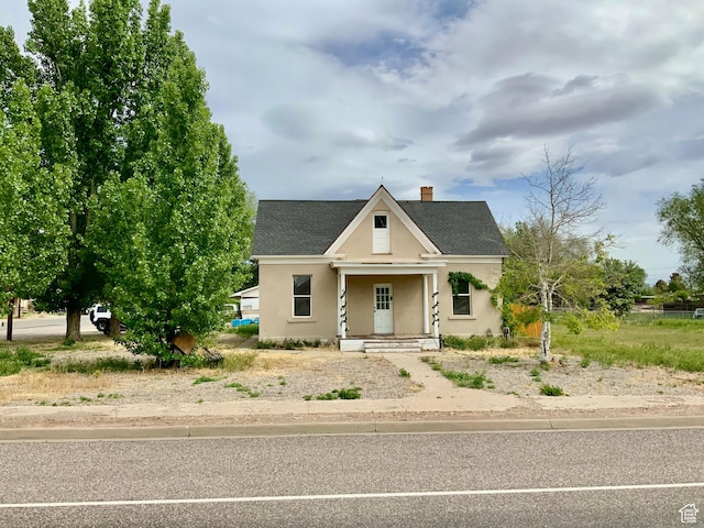 209 E 300 N, Richfield, UT 84701 - view of front of home with a shingled roof, a chimney, stucco siding, and a porch