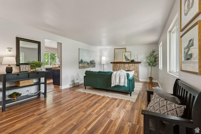 11842 S Elm Ridge Rd E, Sandy, UT 84094 - living room featuring wood finished floors, baseboards, and a stone fireplace