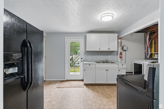 493 N 1025 W St W, Orem, UT 84057 - kitchen featuring black appliances, washer / dryer, a sink, white cabinets, and a textured ceiling