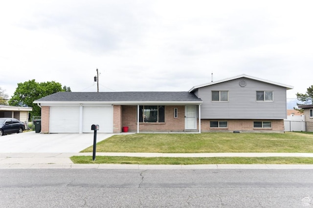 2979 S 2855 W, West Valley City, UT 84119 - tri-level home featuring a garage, concrete driveway, and brick siding