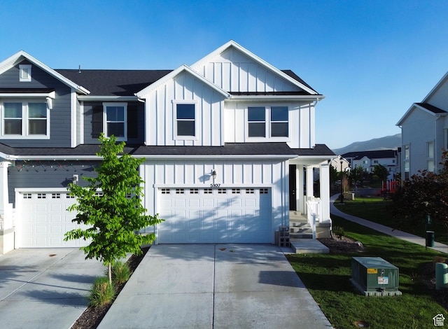 5107 W Harlow Way, Herriman, UT 84096 - view of front facade featuring board and batten siding, an attached garage, and driveway