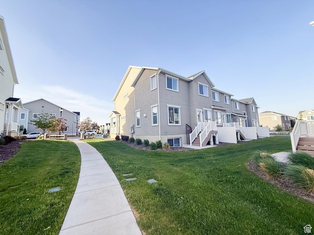 5107 W Harlow Way, Herriman, UT 84096 - view of side of property featuring a residential view, stairs, a lawn, and stucco siding