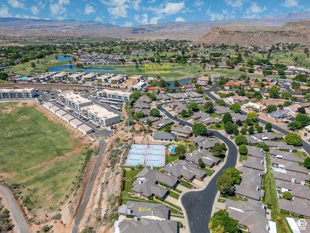 aerial view of property and surrounding area with a water and mountain view and nearby suburban area
