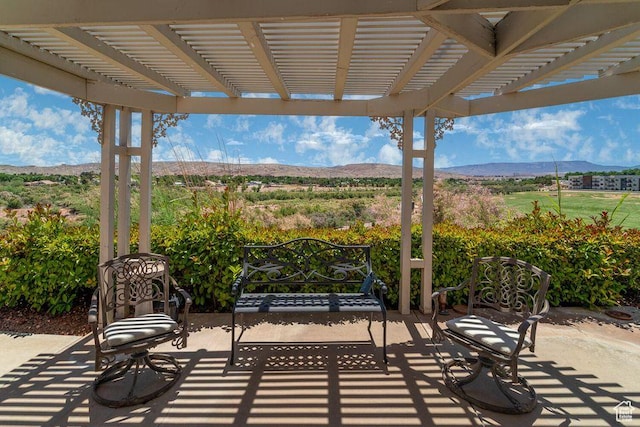 view of patio / terrace with a mountain view and a pergola